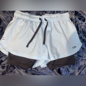 Athletic shorts with attached compressions